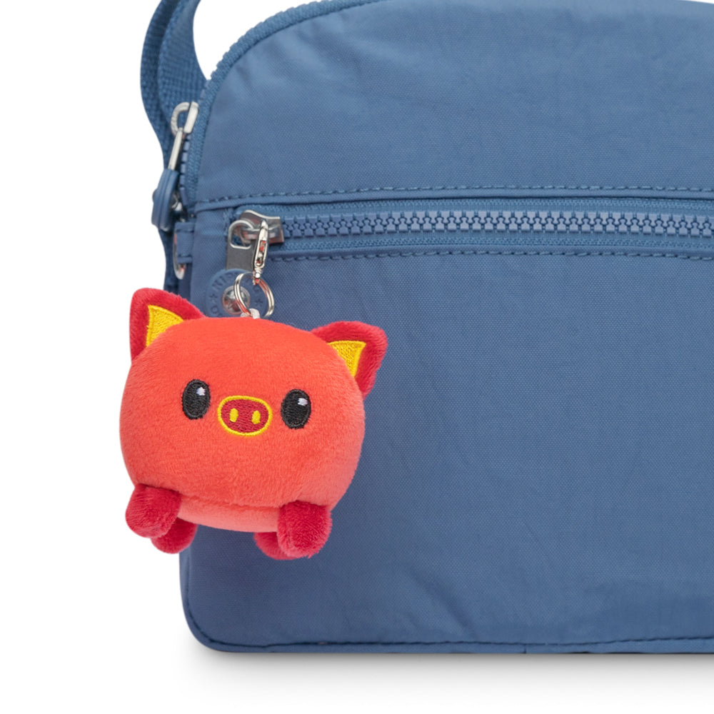 A Lunar New Year themed blue bag with a TeeTurtle Lunar New Year Pig Plushie Charm Keychain.