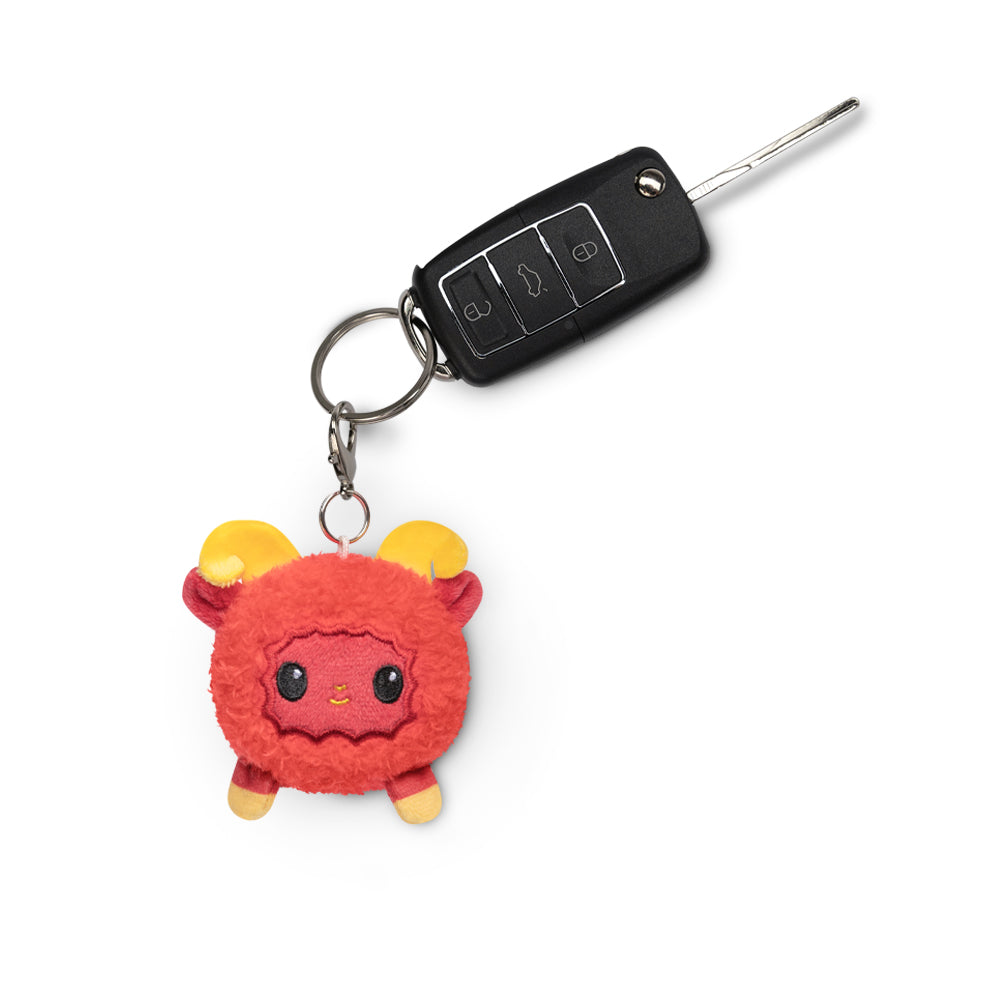 A TeeTurtle Lunar New Year Ram Plushie Charm Keychain, perfect for attaching to a backpack.