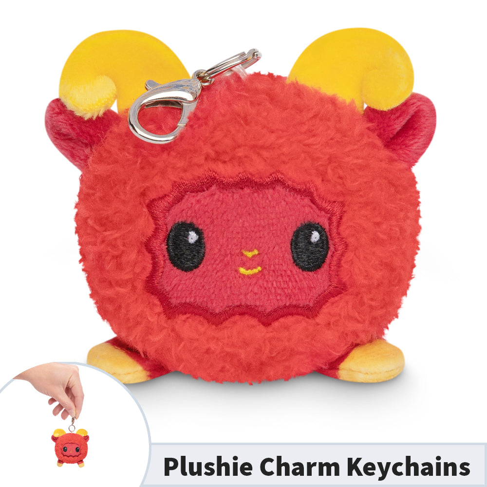 A TeeTurtle Lunar New Year Ram Plushie Charm Keychain featuring a red stuffed animal with a horn on it.