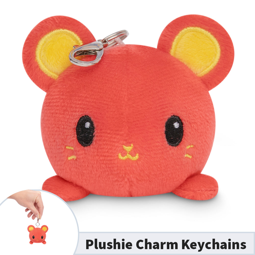 A red TeeTurtle plushie rat holds a Lunar New Year Rat Plushie Charm Keychain.