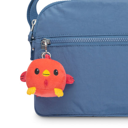 A portable TeeTurtle blue bag with a red TeeTurtle Lunar New Year Rooster Plushie Charm Keychain hanging from it.