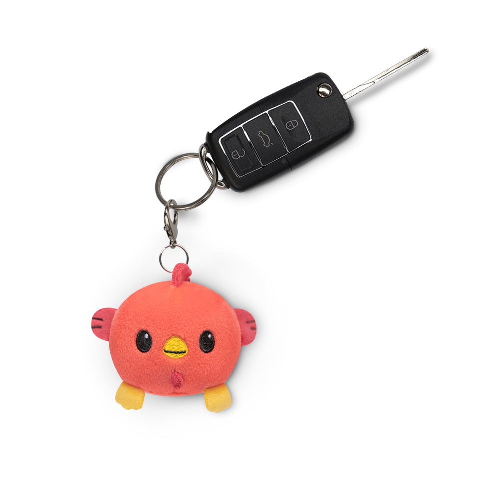 A Lunar New Year Rooster Plushie Charm Keychain featuring a pink bird for TeeTurtle Lunar New Year celebrations.