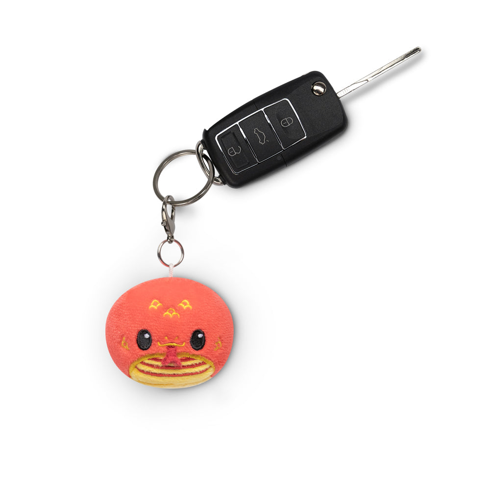 A Lunar New Year Snake Plushie Charm Keychain with a Chinese character on it. (Brand: TeeTurtle)