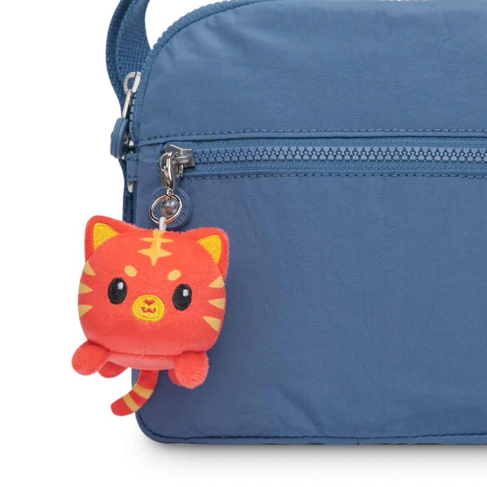 A TeeTurtle Lunar New Year Tiger Plushie Charm Keychain hanging from a blue bag.