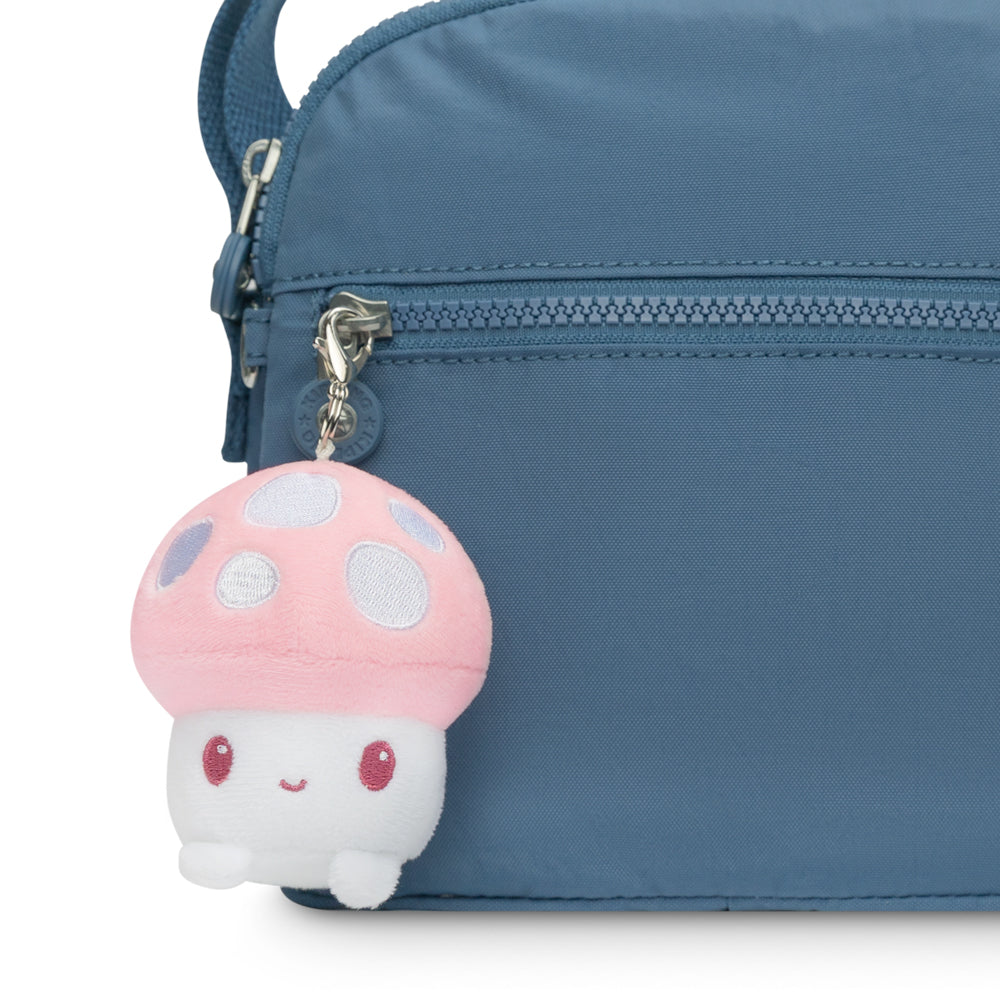 A portable TeeTurtle blue purse with a TeeTurtle pink Mushroom Plushie Charm Keychain.