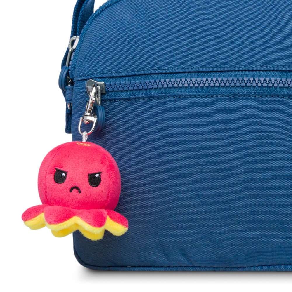 A blue bag with a TeeTurtle Octopus Plushie Charm Keychain.