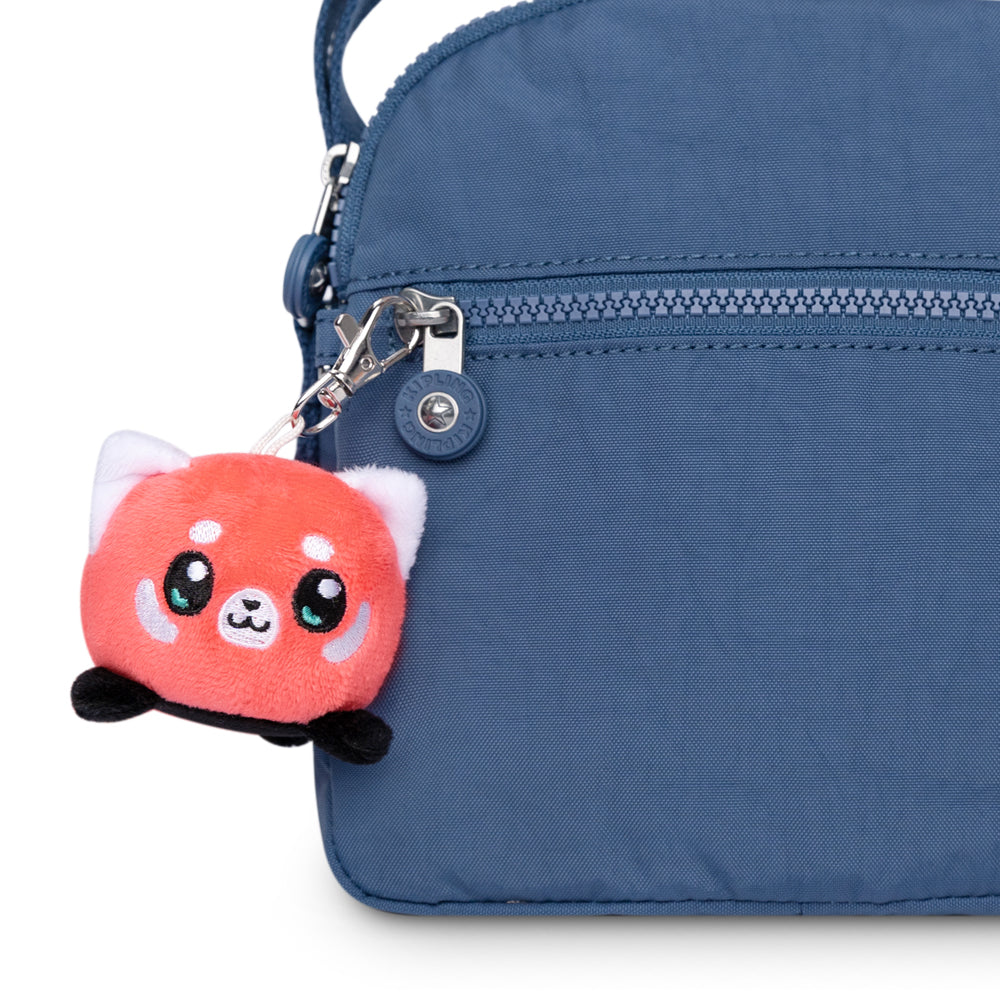 A portable blue purse with a TeeTurtle Red Panda Plushie Charm Keychain.