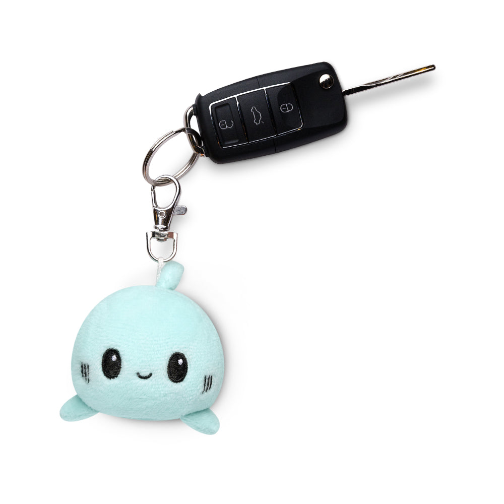 A portable Shark Plushie Charm Keychain featuring a blue whale with a car key attached by TeeTurtle.