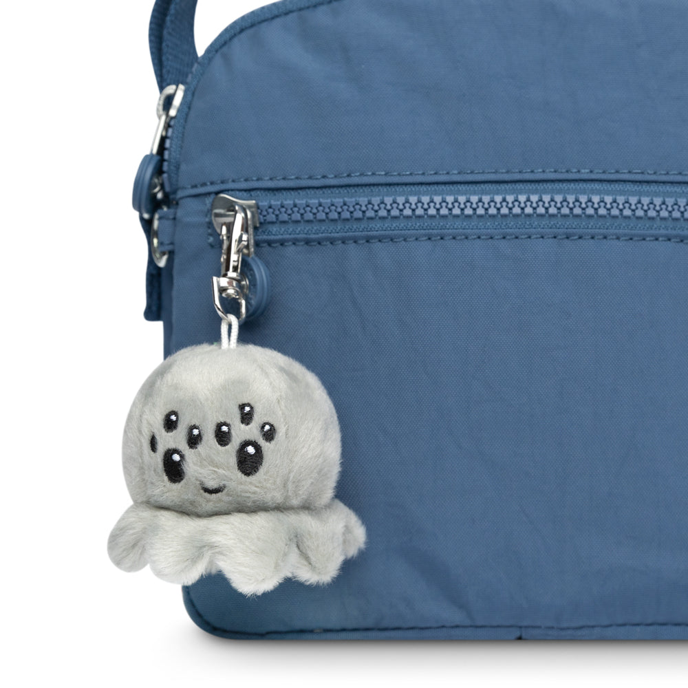 A blue purse with a portable Spider Plushie Charm Keychain from TeeTurtle.