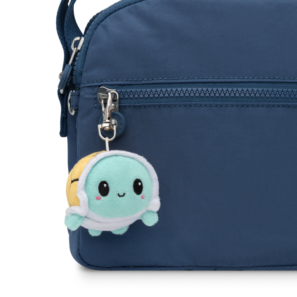 A portable blue TeeTurtle purse with a small TeeTurtle Turtle Plushie Charm Keychain attached to it.