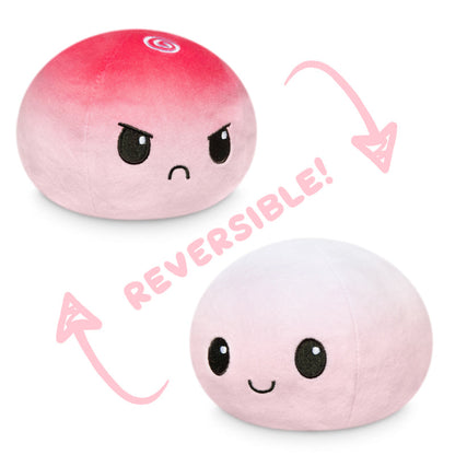 A Reversible Ball Plushie by TeeTurtle, in pink and white.