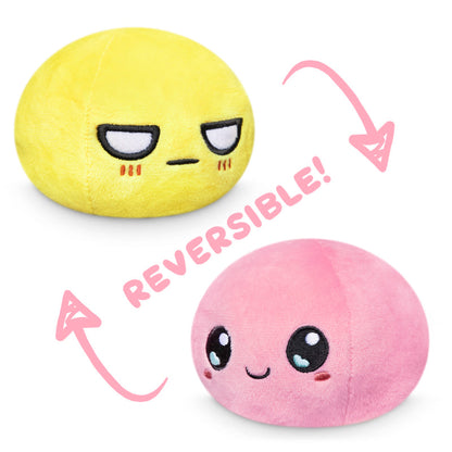 A Reversible Ball Plushie by TeeTurtle with pink and yellow colors.