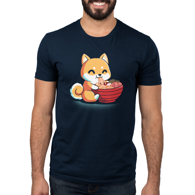 Premium Cotton T-shirt_The Ramen Shiba design from monsterdigital features a cute cartoon Shiba Inu dog happily eating a large bowl of ramen noodles with various toppings, all printed on a super soft ringspun cotton navy blue apparel. The dark background adds an extra charm to this cozy and stylish tee.