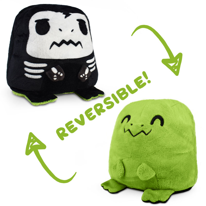 A reversible black and green Reversible T-Rex Plushie from TeeTurtle, perfect for mood plushies enthusiasts.