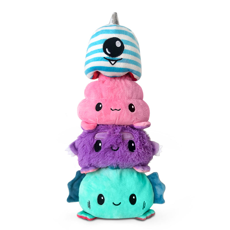 A stack of TeeTurtle Reversible Spookie Dookie Plushie stuffed animals.