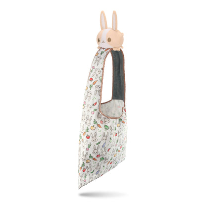 A Veggie Bunny plushie tote bag by TeeTurtle with a bunny head on it.