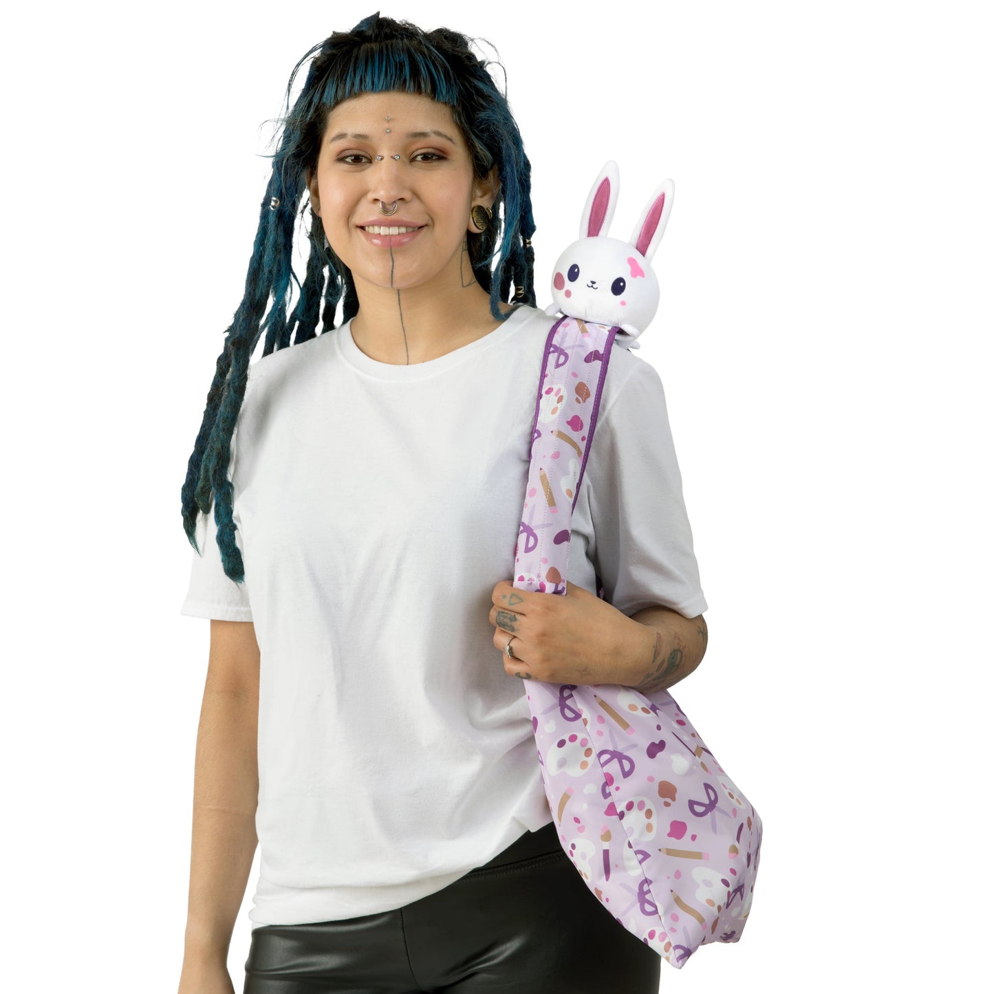 A woman with dreadlocks hugging a TeeTurtle Crafting Bunny Plushie Tote Bag.