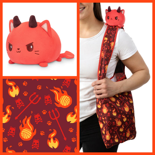 A woman is holding a Devil Cat Plushie Tote Bag with flames on it. The tote bag is by TeeTurtle.