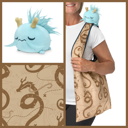 A woman is holding a TeeTurtle Fantasy Dragon Plushie Tote Bag, perfect for storing plushies.