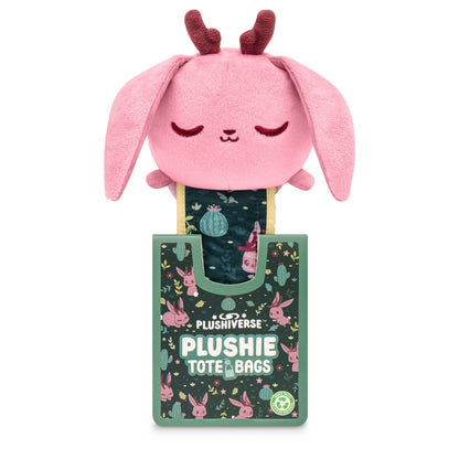 A Plushiverse Fearsome Jackalope plushie tote bag with pink ears and a serene expression, protruding from a decorative green box labeled "TeeTurtle".