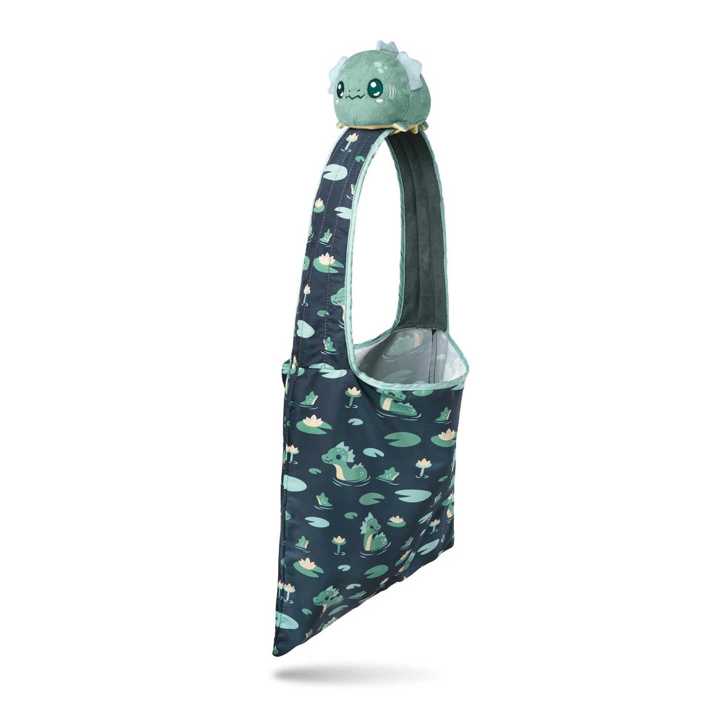 A Plushiverse Elusive Nessie Plushie Tote Bag featuring a plushie bulbasaur head on the strap, with a pattern of various pokémon on a navy background by TeeTurtle.