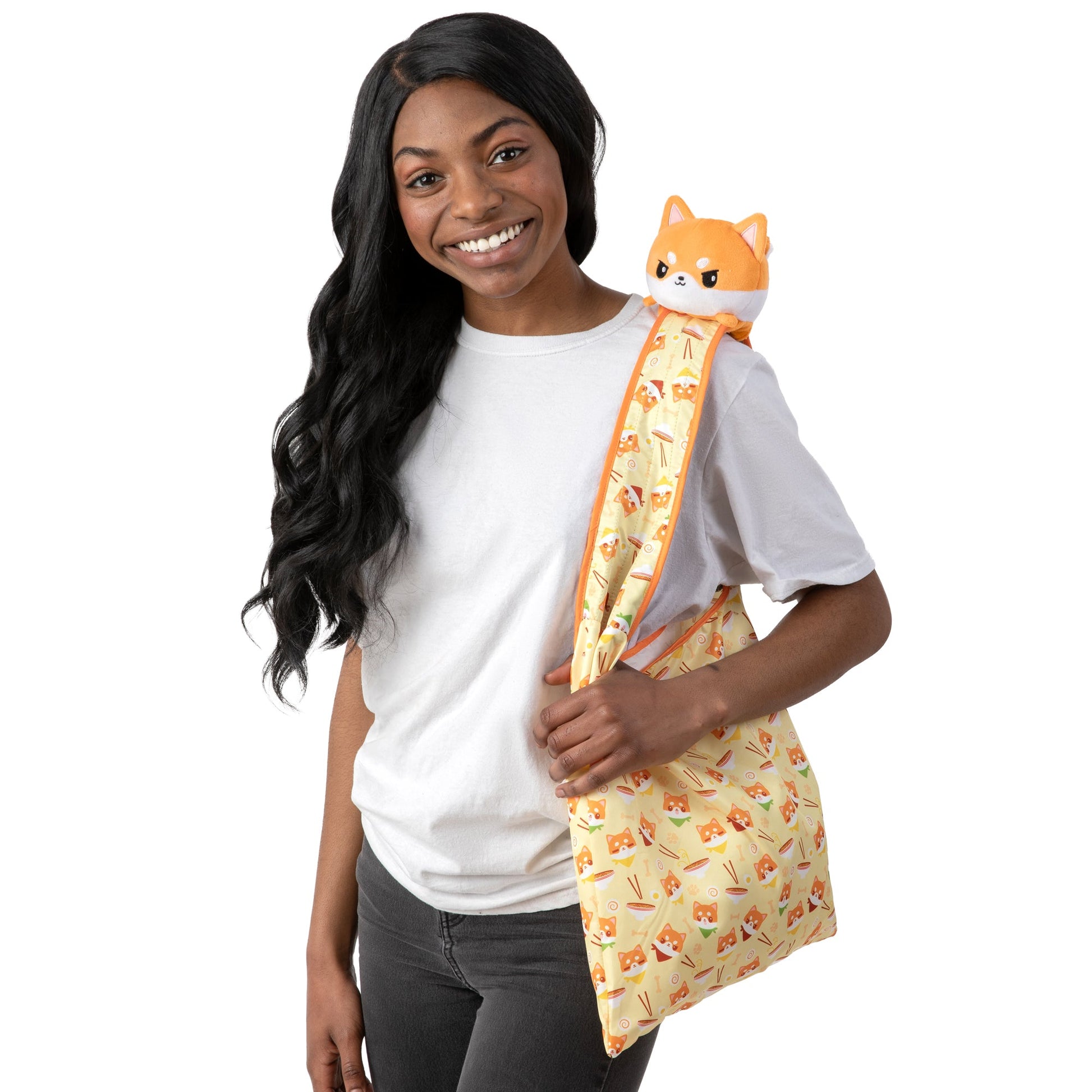 A young woman cuddling a Ramen Shiba Inu Plushie Tote Bag by TeeTurtle.