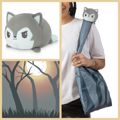 A woman is holding a TeeTurtle Forest Wolf Plushie Tote Bag.