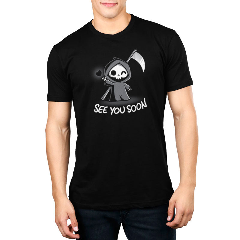 Premium Cotton T-shirt_TeeTurtle See You Soon black t-shirt featuring a spooky cartoon Grim Reaper holding a scythe, waving, and a floating black heart next to it, with the text below that says in dark humor "SEE YOU SOON". 