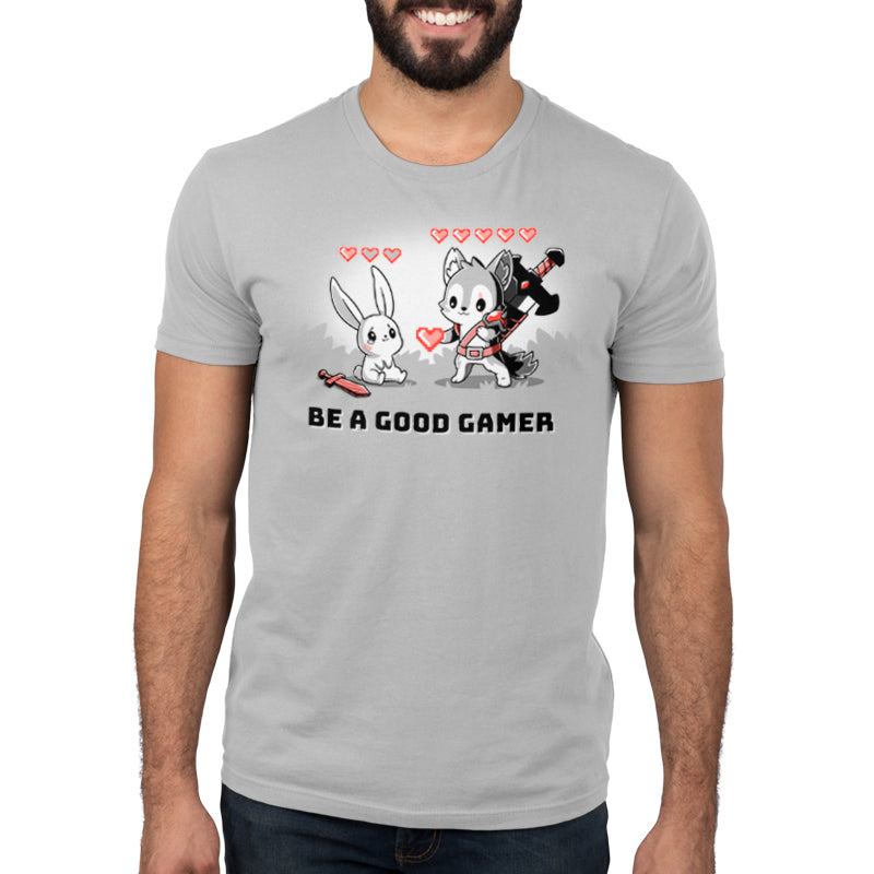 Premium Cotton T-shirt_TeeTurtle Be a Good Gamer silver gray t-shirt featuring a gray wolf character in armor with 5 life hearts above him offering a video game style life heart to an injured bunny who only has one life heart left sitting crying next to a sword. Text below reads, "BE A GOOD GAMER." 