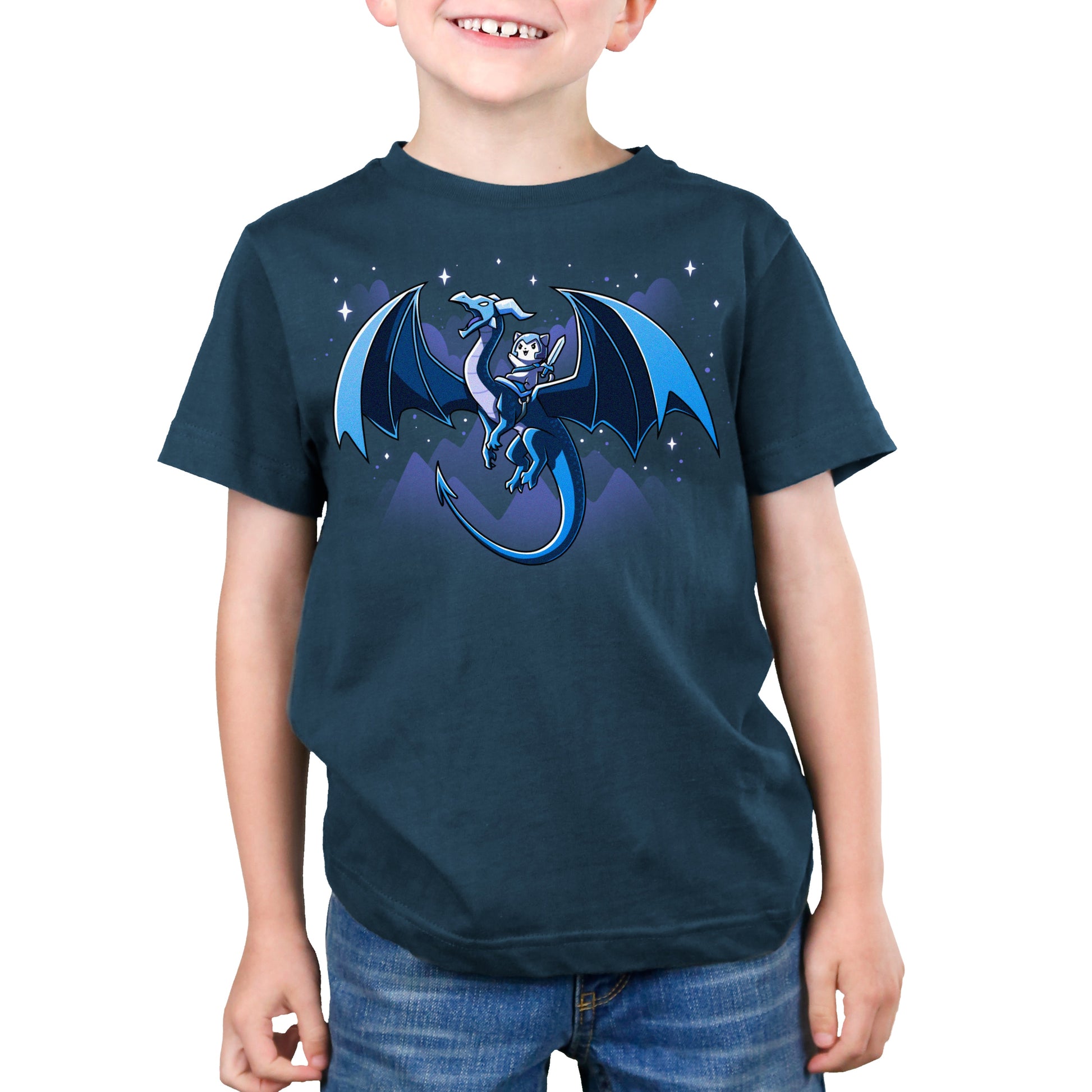 Premium Cotton T-shirt_TeeTurtle Dragon Rider denim blue t-shirt featuring a dragon with large wings flies through a night sky with mountain silhouettes and stars in the background, carrying a person in armor and a hood on its back.