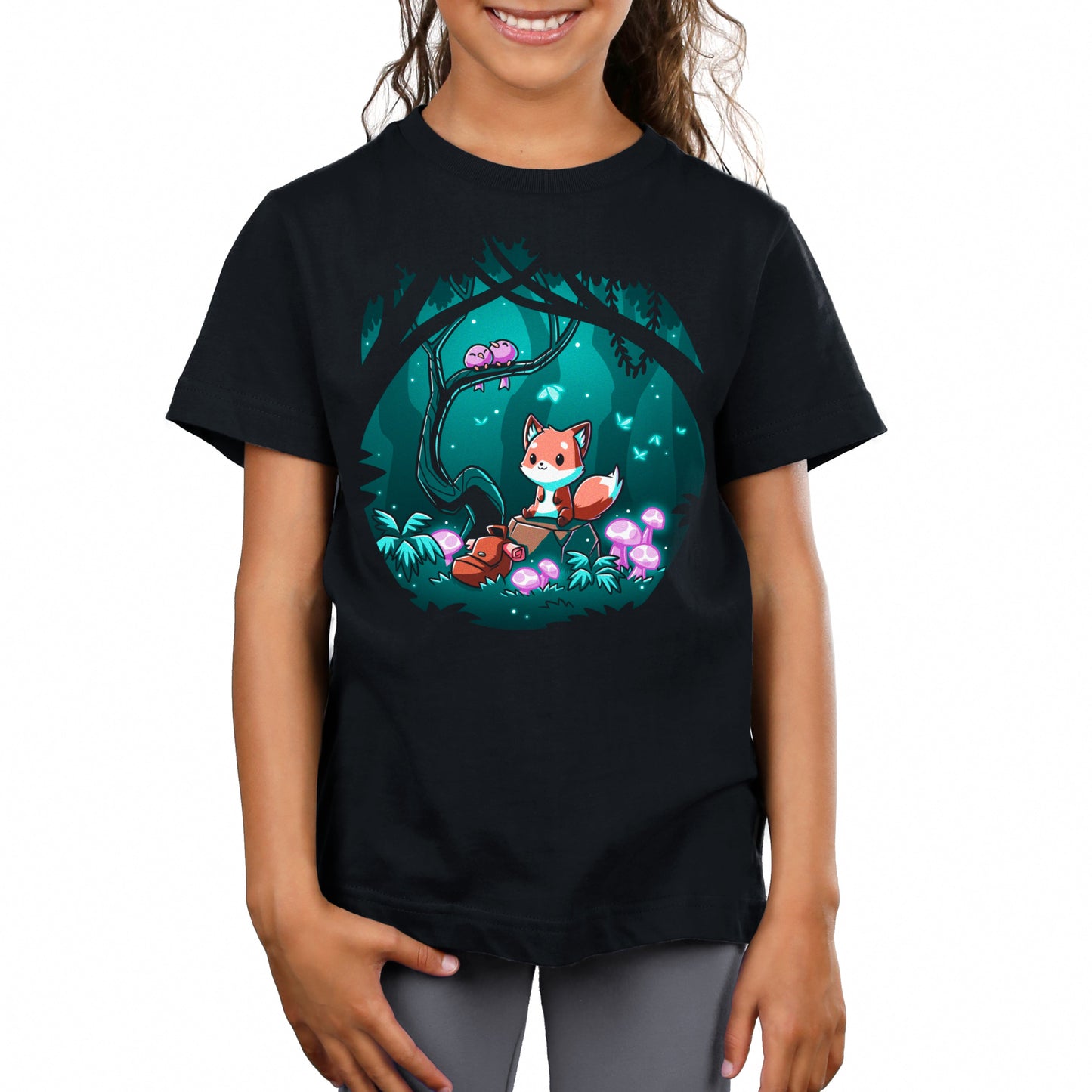 Premium Cotton T-shirt_TeeTurtle Enchanted Forest black t-shirt featuring a cute fox sitting on a log in a magical enchanted forest at night, surrounded by glowing mushrooms and two birds perched on a tree branch.