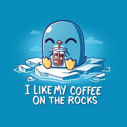 Premium Cotton T-shirt - A blue cartoon penguin sits on ice, happily holding a cup of iced coffee with a straw, sporting a cobalt blue apparel. The text below reads, "I Like My Coffee on the Rocks by monsterdigital.