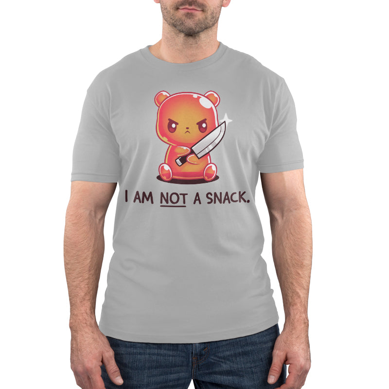 Premium Cotton T-shirt_TeeTurtle I Am Not A Snack silver gray t-shirt featuring a semi-translucent orange gummy bear holding a large kitchen knife looking angry. Beneath it there's text saying "I am not a snack"