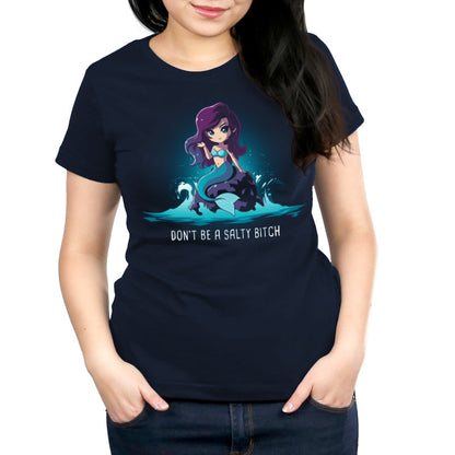 Premium Cotton T-shirt_TeeTurtle Salty Beach navy blue t-shirt featuring a magical purple-haired mermaid with a teal tail sitting on a rock in the ocean, with the pun "Don't be a Salty Beach" at the bottom.