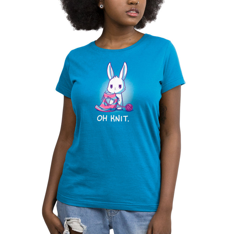 Premium Cotton T-shirt_Teeturtle Oh Knit Cobalt Blue featuring a white rabbit looking distraught. It's holding two knitting needles attached to a blue and pink striped scarf that has a large hole in the middle. There is a ball of pink yarn trailing off to the side and text beneath it that says "Oh knit."