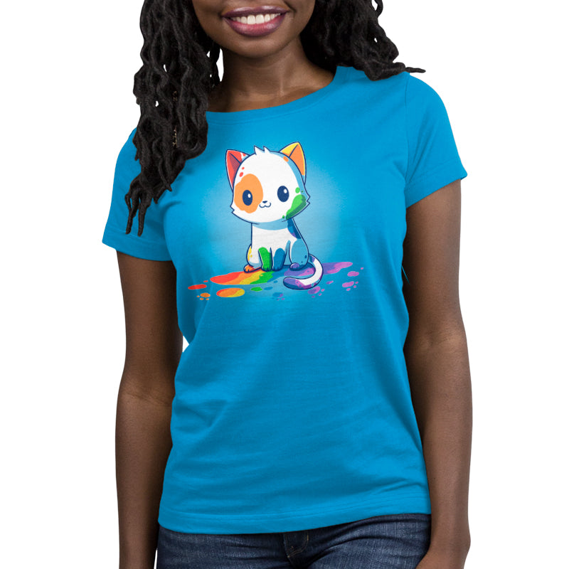 Premium Cotton T-shirt_TeeTurtle Rainbow Cat Cobalt Blue t-shirt featuring an illustration of a white cartoon kitten with colorful paint splashes on its body, sitting on a floor with rainbow-colored paint drops around it. 