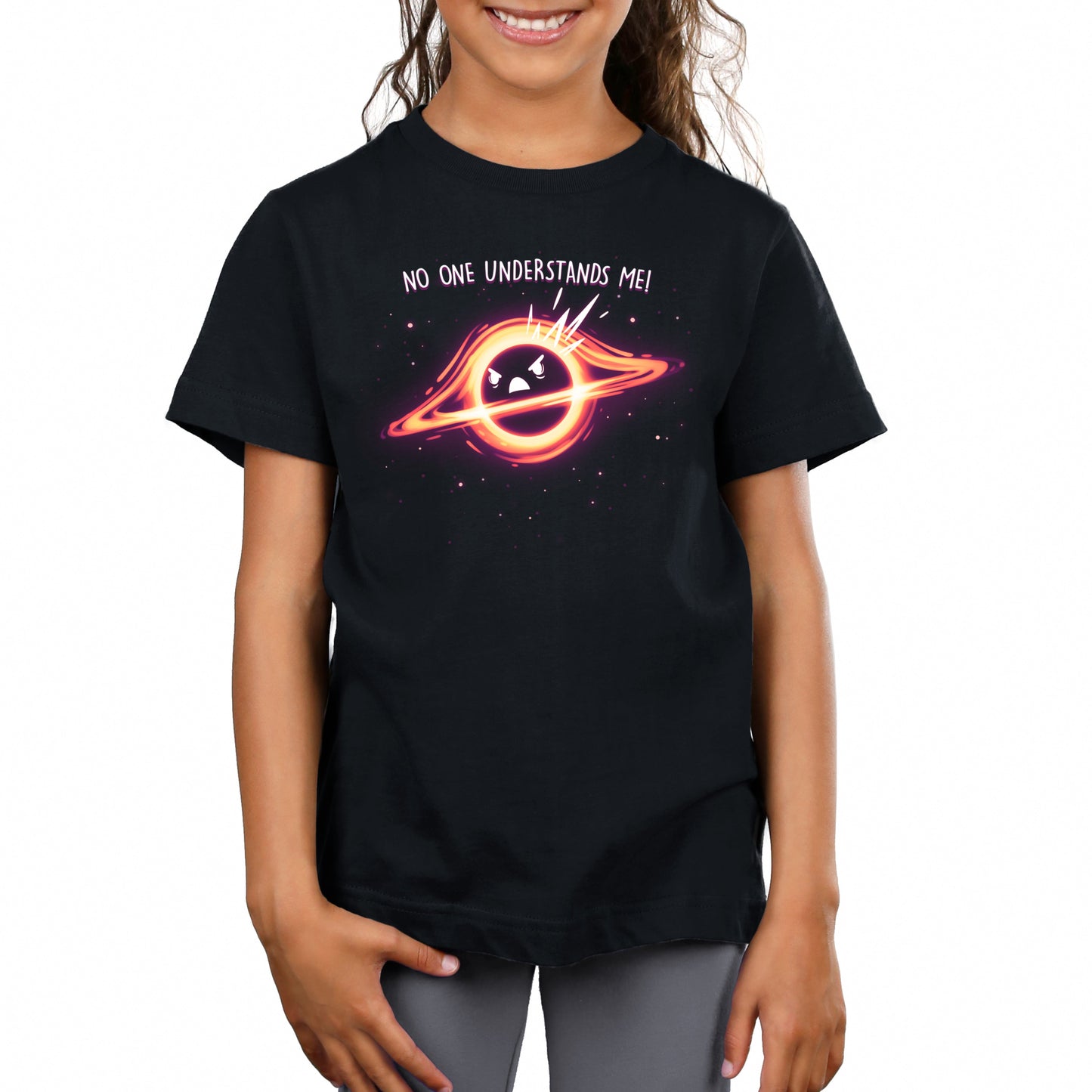 Premium Cotton T-shirt - Young girl wearing a black Monsterdigital Black Hole Angst unisex apparelfeaturing a graphic of a planet with a face inside a ring, and the text "no one understands me!" against a starry background.