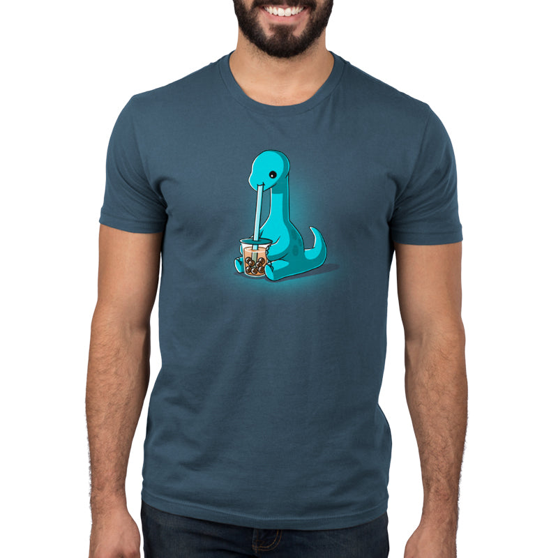 Premium Cotton T-shirt_TeeTurtle Boba Dinosaur Denim t-shirt featuring a cartoon dinosaur sipping bubble tea through a large straw. The dinosaur is blue with a long neck and tail, seated against a dark background. 