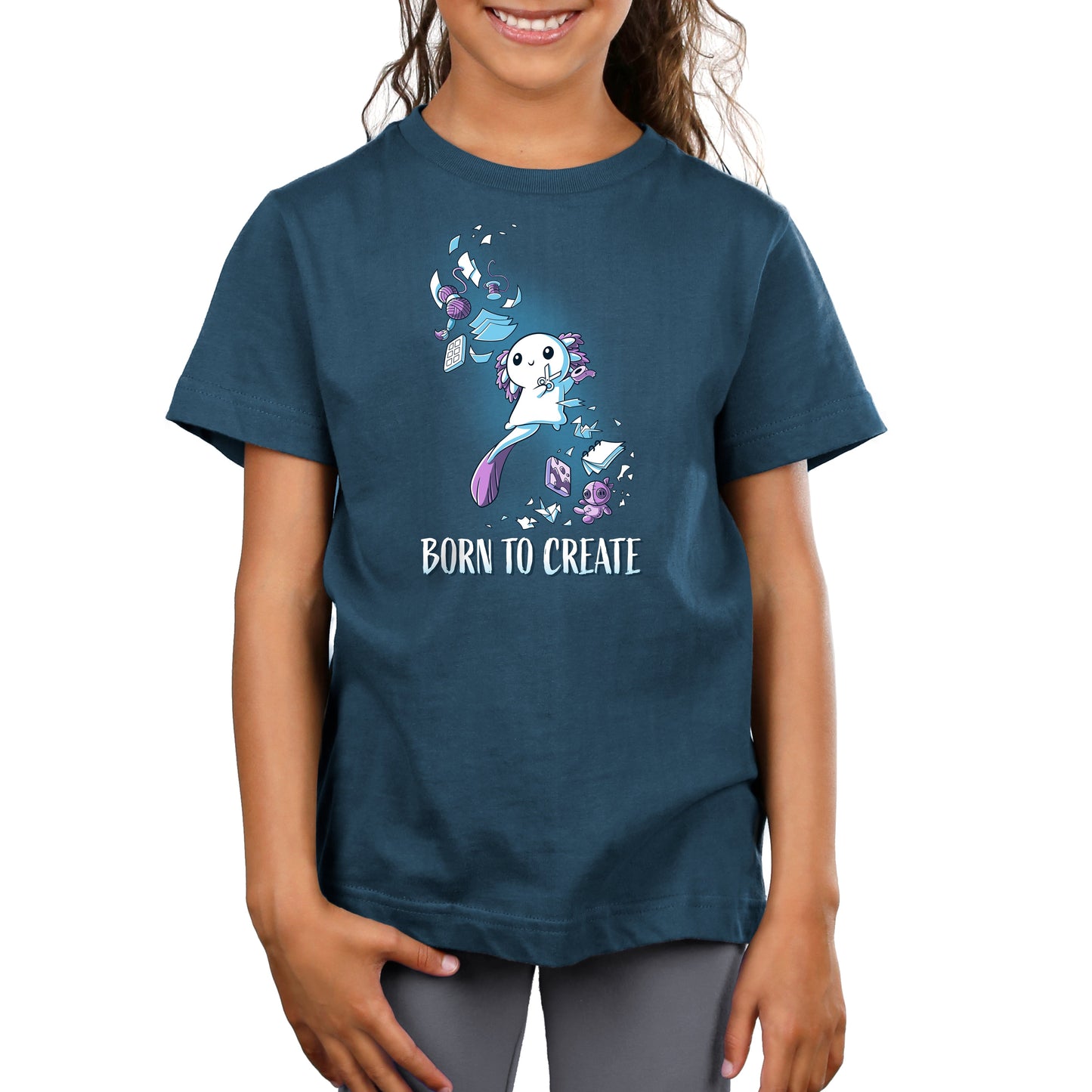 Premium Cotton T-shirt - A child wearing a denim blue apparel crafted from super soft ringspun cotton, featuring an illustration of a white animal character surrounded by creative elements and the text "Born to Create" by monsterdigital.