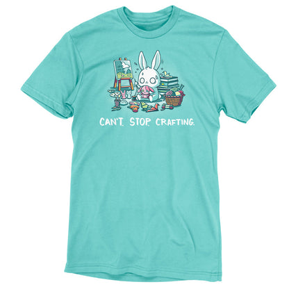 Premium Cotton T-shirt_TeeTurtle Can't. Stop. Crafting. Caribbean blue t-shirt featuring an illustration of a white rabbit with large, expressive eyes, and sweat droplets coming from its head sewing a small pink bunny surrounded by crafting materials like balls of yarn in a woven basket, paint pallets and brushes,  origami birds and other shapes, sewing thread, small stuffed animals, books stacked high, craft knives, and other crafting supplies, with the text "CAN'T. STOP. CRAFTING." at the bottom.