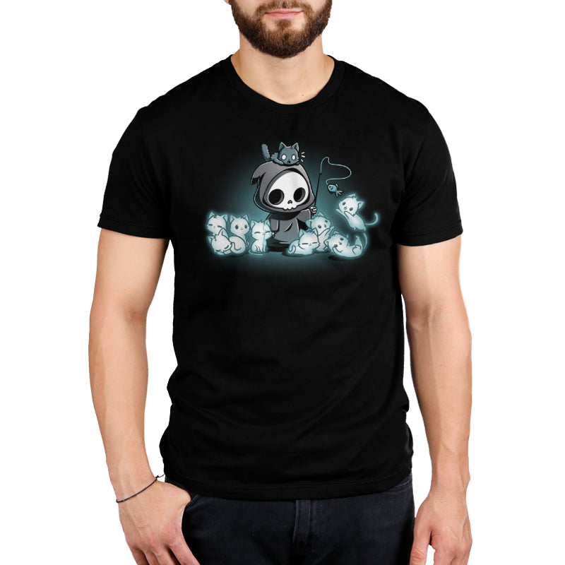 Premium Cotton T-shirt_TeeTurtle Grim and Kitties black t-shirt featuring a hooded skeleton figure, resembling a spooky Grim Reaper, standing surrounded by glowing ghostly cats. One cat is perched on its head while it playfully dangles a toy fish in front of the others.