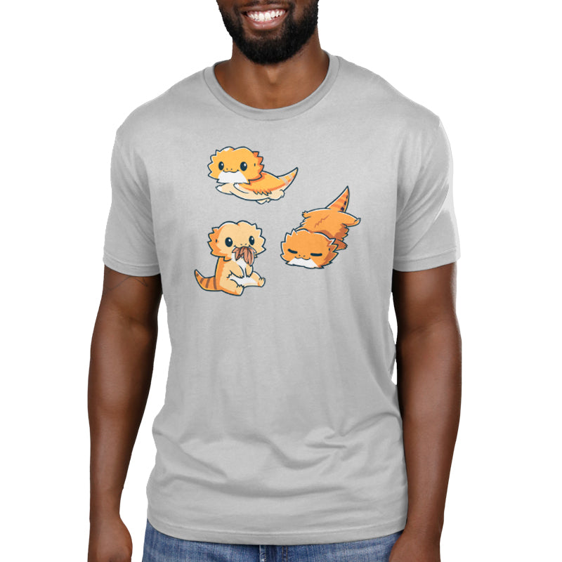 Premium Cotton T-shirt_TeeTurtle Lil Bearded Dragons Silver Gray t-shirt featuring three cartoon-style illustrations of Lil' Bearded Dragons in various poses: sitting and holding food, laying down, and standing on all fours with a happy expression.