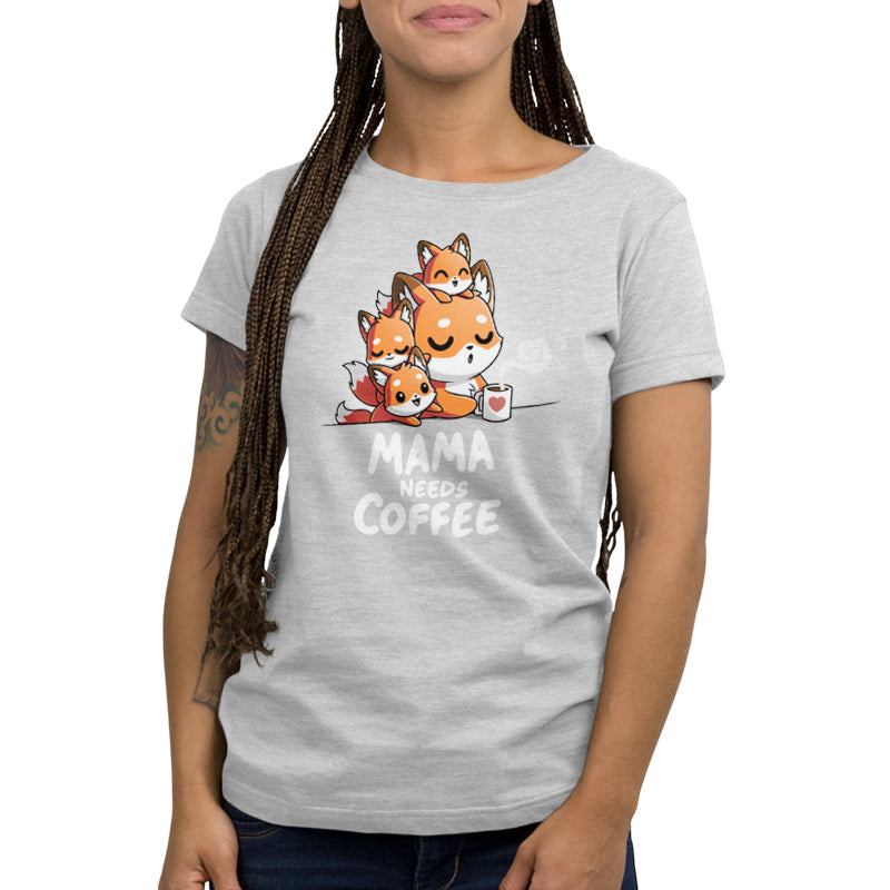 Premium Cotton T-shirt_TeeTurtle- Mama Needs Coffee Silver Gray t-shirt featuring illustration of a tired fox holding a coffee mug on gray background, with three small foxes climbing on her. 