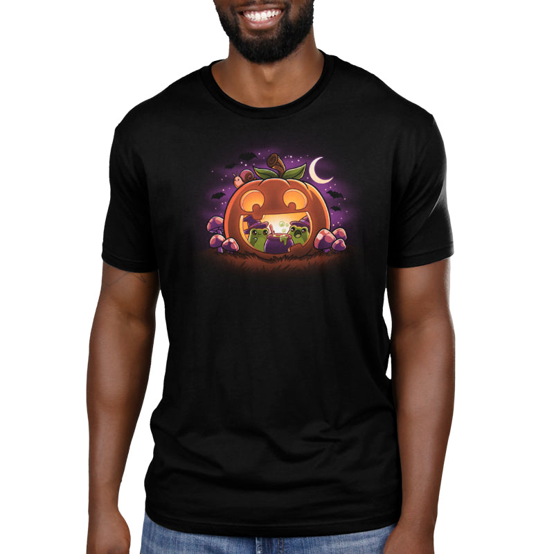 Premium Cotton T-shirt_TeeTurtle Pumpkin Frog Witches black t-shirt featuring two frogs wearing witch hats brewing a cauldron of potion inside of a happy Halloween jack-o-lantern.