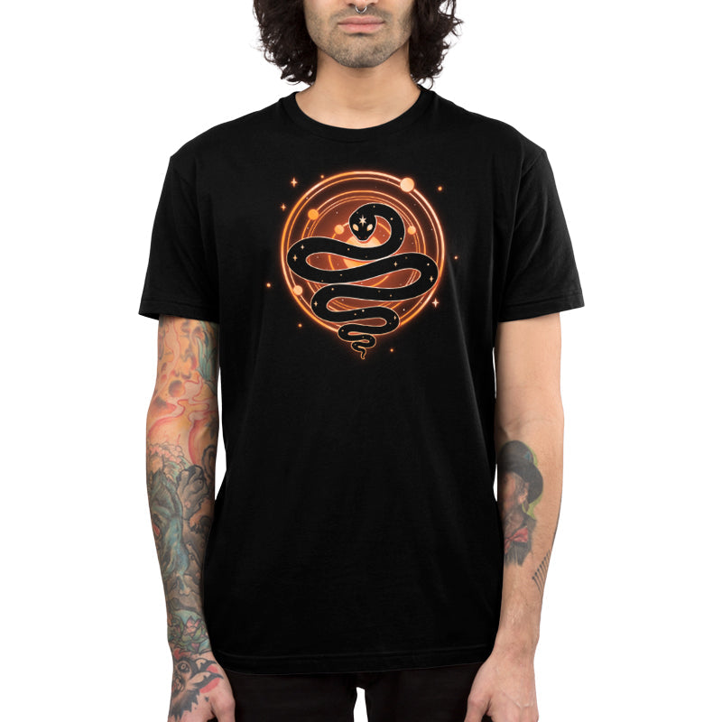 Premium Cotton T-shirt_TeeTurtle Serpent of Cosmos black t-shirt featuring a stylized black snake with white stars on its body who is coiled in front of a glowing circle with smaller orange circles and dots, resembling a cosmic or celestial symbol. 