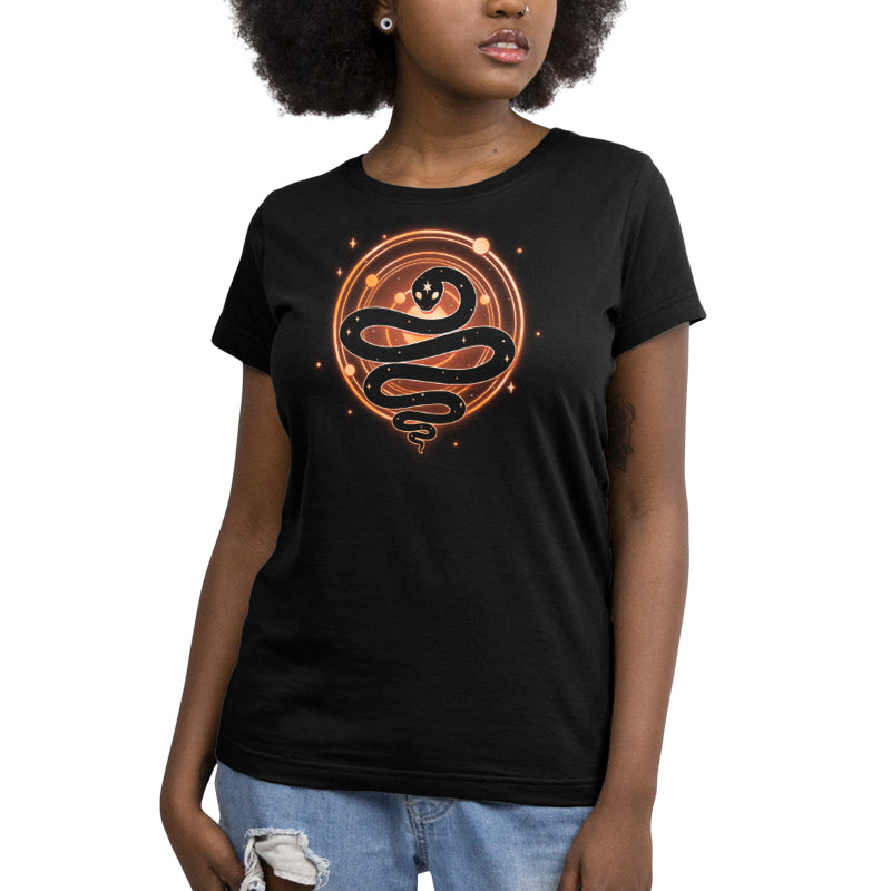 Premium Cotton T-shirt_TeeTurtle Serpent of Cosmos black t-shirt featuring a stylized black snake with white stars on its body who is coiled in front of a glowing circle with smaller orange circles and dots, resembling a cosmic or celestial symbol. 