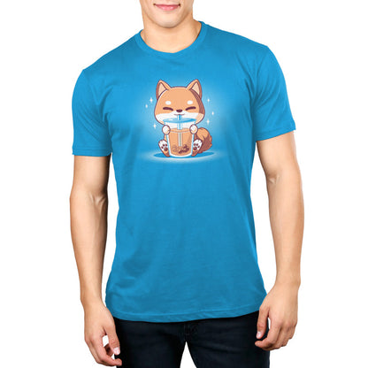 Premium Cotton T-shirt_TeeTurtle Boba Shiba Cobalt Blue t-shirt featuring a cartoon fox happily drinking Boba Shiba from a cup with a straw, set against a blue background with sparkles.