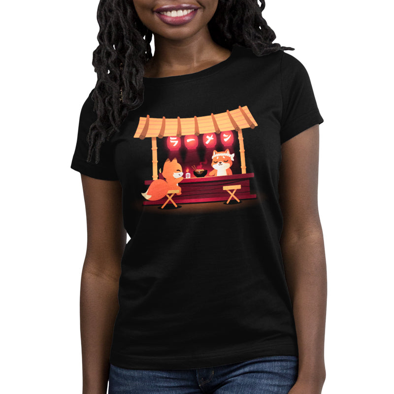 Premium Cotton T-shirt_TeeTurtle Shiba's Ramen Stall black t-shirt featuring an orange fox sitting being served by an orange shiba inu at a food stall. The stall is decorated with red lanterns and a bowl of steaming noodles is being served. 