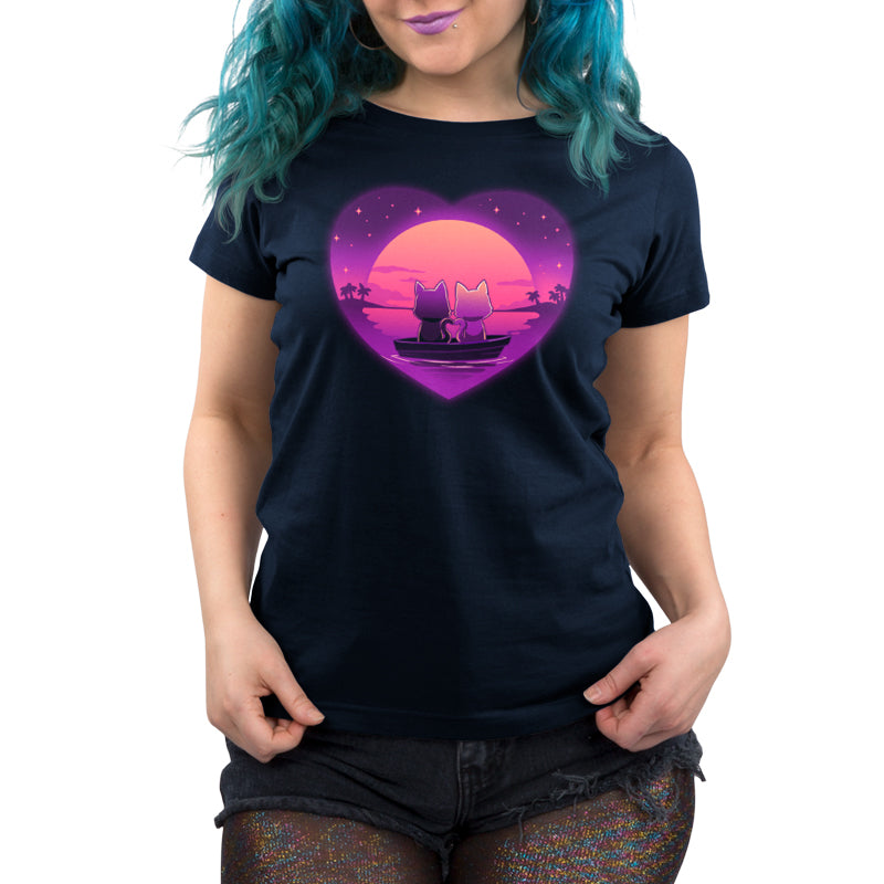 Premium Cotton T-shirt_TeeTurtle Sunset Romance navy blue t-shirt featuring two cats sitting in a boat on calm water, gazing at a colorful sunset framed by a heart shape, with a starry sky and palm trees in the background.