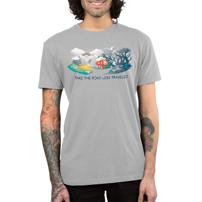 Premium Cotton T-shirt_TeeTurtle The Road Less Traveled silver gray t-shirt featuring an illustration of a rabbit at a crossroads, one path leading to a vibrant, colorful landscape under a rainbow, and the other to a dark forest; text below reads "TAKE THE ROAD LESS TRAVELED." 